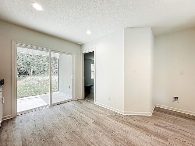 921 Helen St, Saint Augustine, FL 32084 - spare room with light wood-type flooring, baseboards, recessed lighting, and a textured ceiling