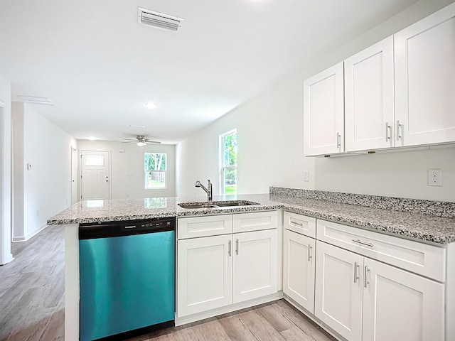 921 Helen St, Saint Augustine, FL 32084 - kitchen featuring dishwashing machine, a sink, a peninsula, light wood finished floors, and white cabinetry
