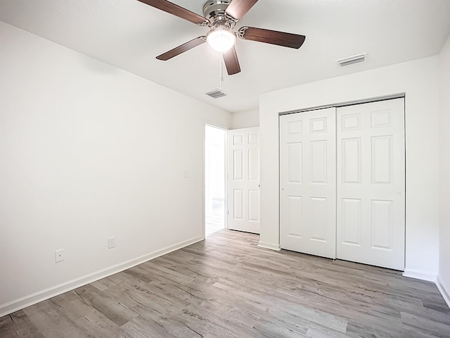 921 Helen St, Saint Augustine, FL 32084 - unfurnished bedroom with wood finished floors, baseboards, a closet, and a ceiling fan