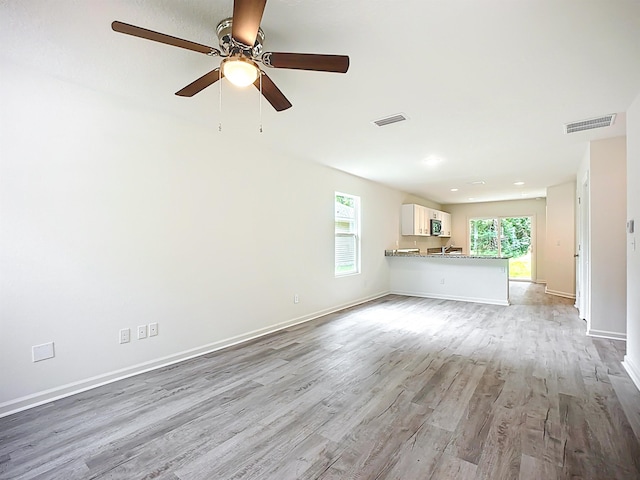 921 Helen St, Saint Augustine, FL 32084 - unfurnished living room featuring wood finished floors, a ceiling fan, and baseboards