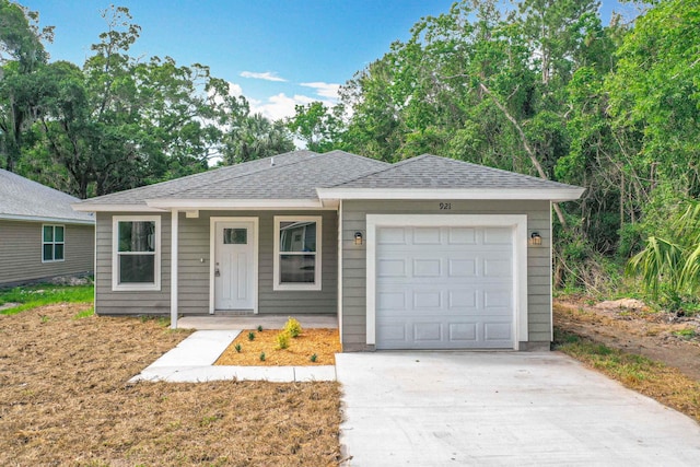 921 Helen St, Saint Augustine, FL 32084 - ranch-style house with driveway, an attached garage, and roof with shingles