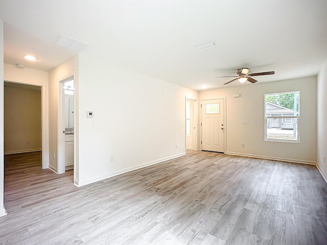 921 Helen St, Saint Augustine, FL 32084 - unfurnished living room with ceiling fan, light wood-style floors, and baseboards