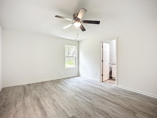 921 Helen St, Saint Augustine, FL 32084 - unfurnished bedroom featuring wood finished floors, baseboards, ensuite bath, and a ceiling fan
