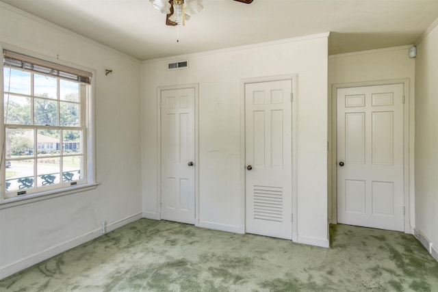 unfurnished bedroom with ceiling fan, light colored carpet, and ornamental molding