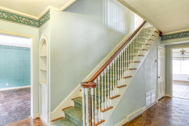 staircase with parquet flooring and ceiling fan