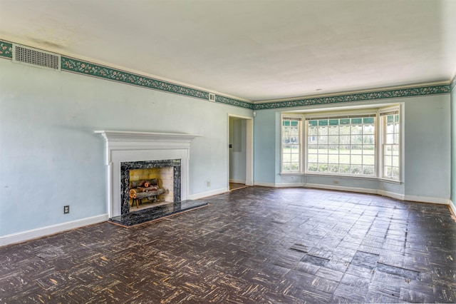 unfurnished living room featuring a premium fireplace