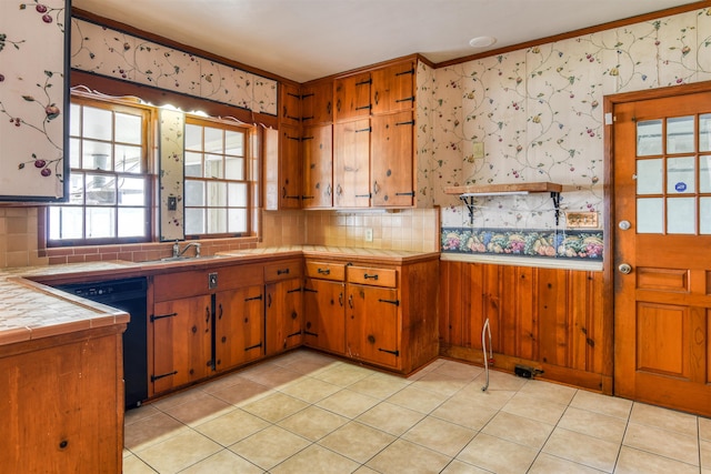 kitchen featuring tile counters, dishwasher, light tile patterned floors, and crown molding