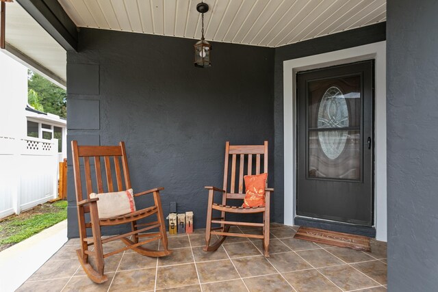 291 Maxwell Dr, Welaka, FL 32193 - doorway to property with stucco siding and a porch