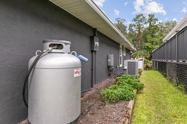 exterior space with a lawn and central AC unit