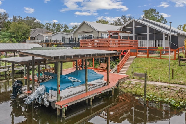 dock area with a lawn and a water view