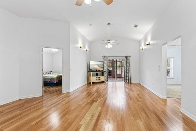 unfurnished living room with ceiling fan, high vaulted ceiling, and light hardwood / wood-style floors