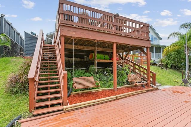 wooden terrace featuring a yard