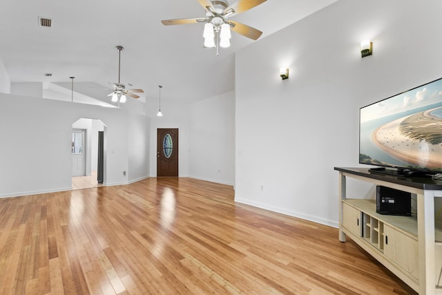 unfurnished living room with light wood-type flooring, ceiling fan, and lofted ceiling