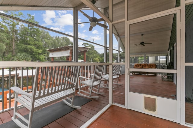 sunroom / solarium featuring ceiling fan and lofted ceiling