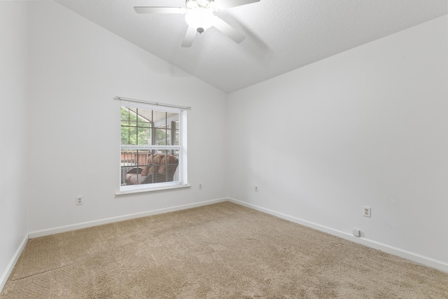 carpeted empty room with ceiling fan and vaulted ceiling