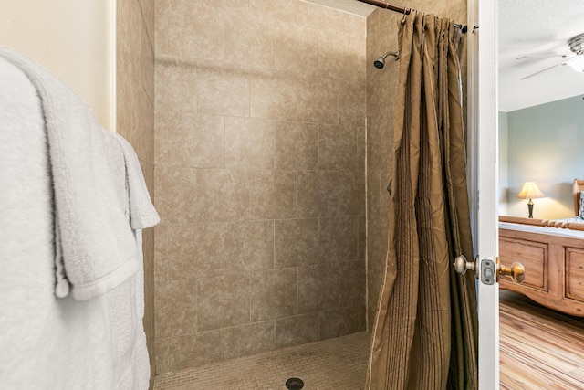 bathroom featuring hardwood / wood-style floors, ceiling fan, and a shower with shower curtain