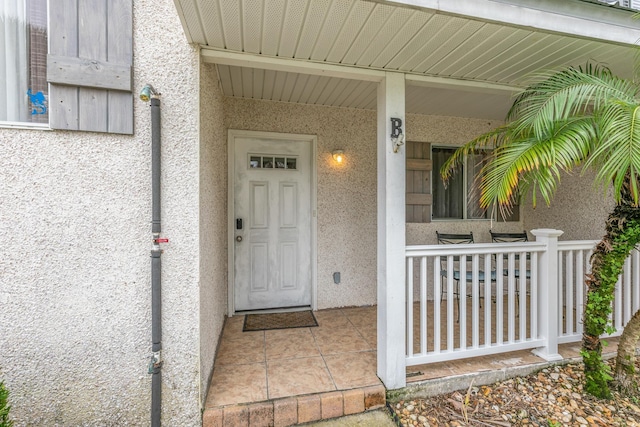 doorway to property featuring covered porch