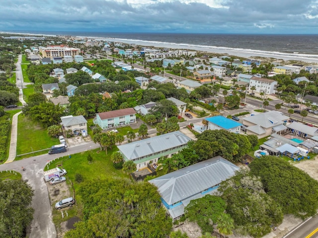 drone / aerial view featuring a beach view and a water view