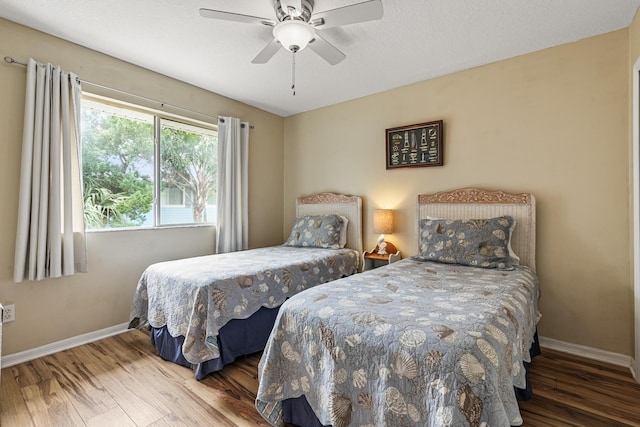 bedroom with hardwood / wood-style floors and ceiling fan