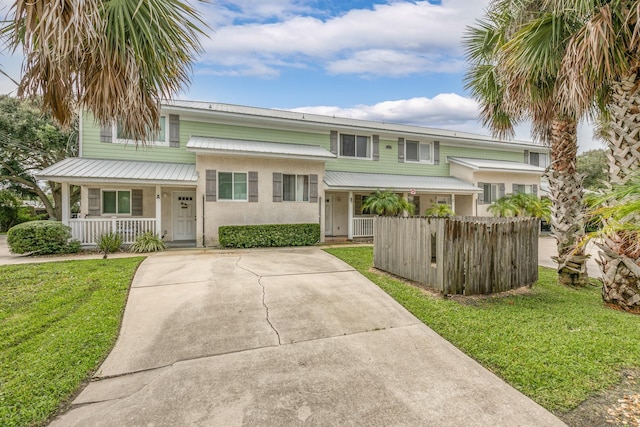 view of front of home featuring covered porch and a front yard