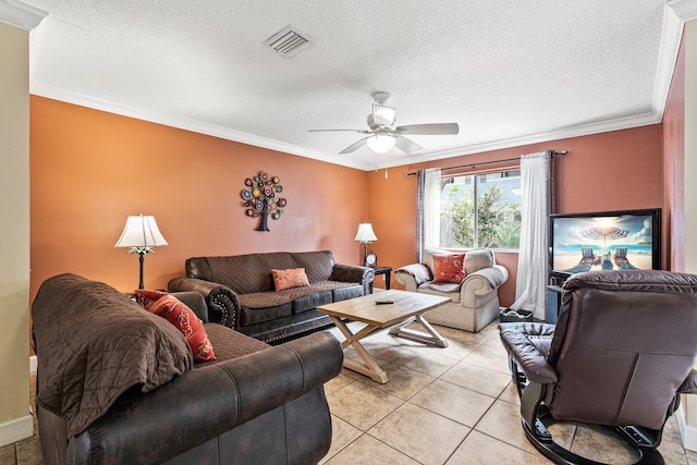 living room with a textured ceiling, ceiling fan, light tile patterned flooring, and crown molding