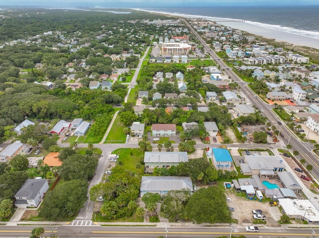 birds eye view of property with a water view and a beach view