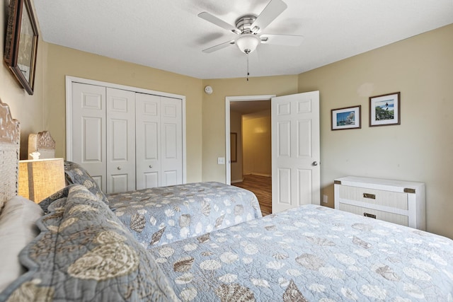 bedroom with hardwood / wood-style floors, ceiling fan, and a closet