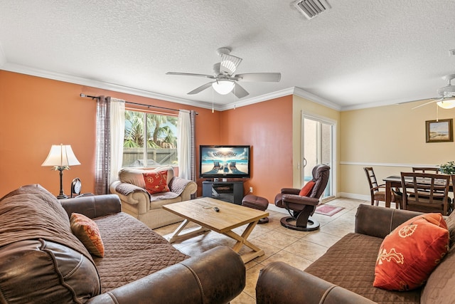 tiled living room featuring ceiling fan, a textured ceiling, and ornamental molding