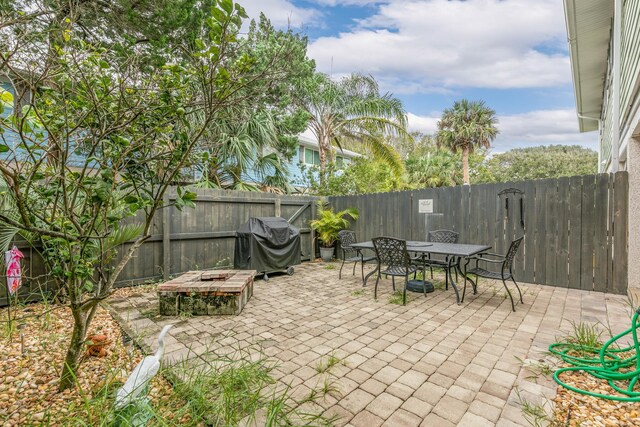 view of patio / terrace with area for grilling and a fire pit