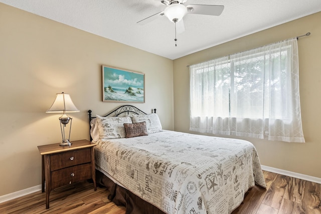 bedroom featuring hardwood / wood-style flooring and ceiling fan