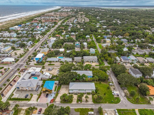 bird's eye view with a water view and a beach view