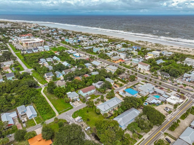 birds eye view of property with a water view and a view of the beach