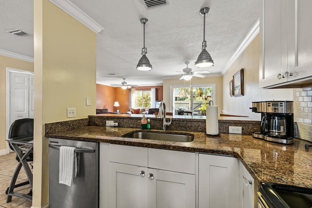 kitchen with white cabinetry, sink, and a textured ceiling