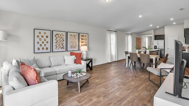 798 Grand Reserve Dr, Bunnell, FL 32110 - living area with wood finished floors, lofted ceiling, recessed lighting, and baseboards