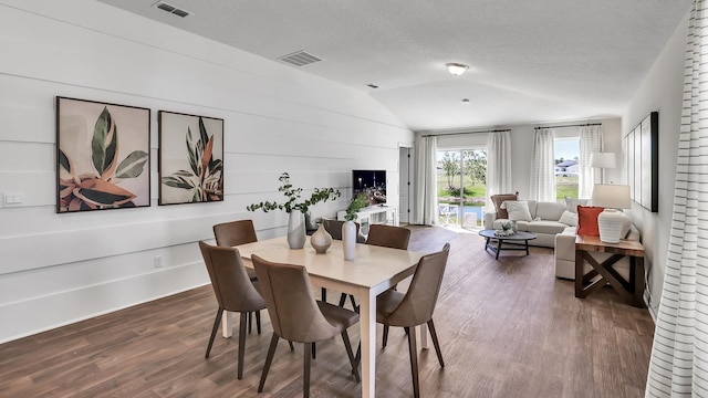 798 Grand Reserve Dr, Bunnell, FL 32110 - dining area with vaulted ceiling, dark wood-style floors, and a textured ceiling
