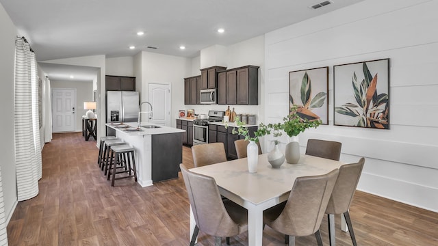 798 Grand Reserve Dr, Bunnell, FL 32110 - dining room with wood finished floors, recessed lighting, and vaulted ceiling