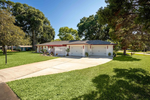 ranch-style home featuring a garage and a front yard