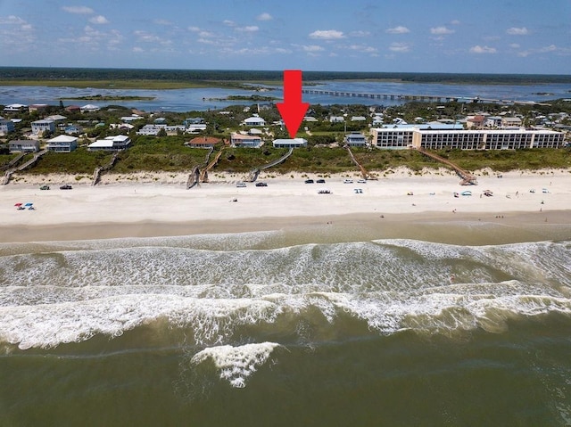 birds eye view of property featuring a water view and a view of the beach