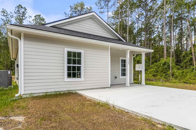 view of home's exterior with a patio and central air condition unit