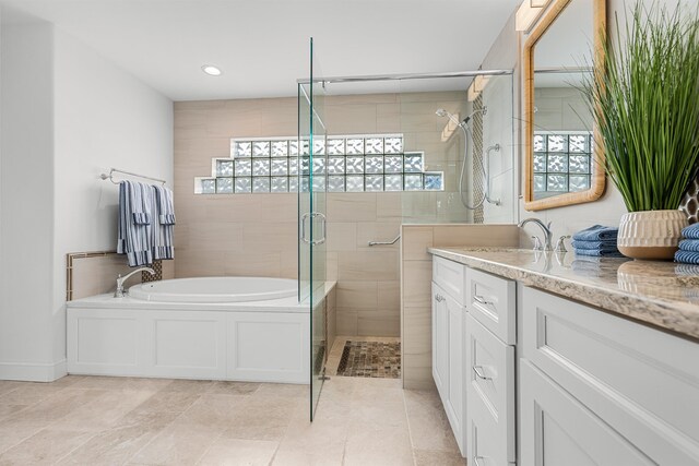 bathroom featuring a garden tub, a shower stall, vanity, and recessed lighting