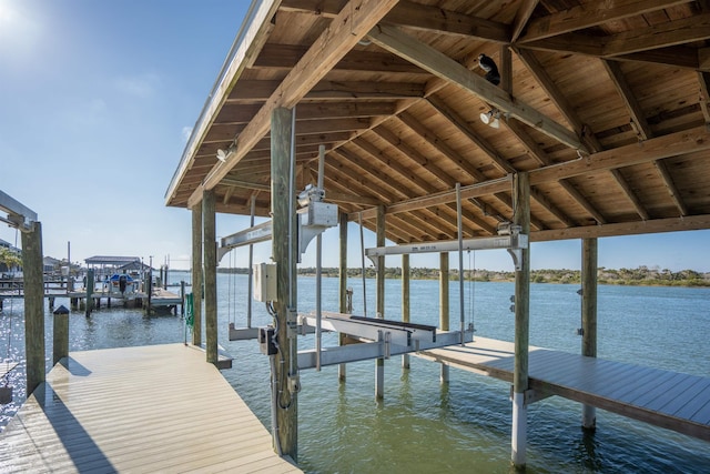 dock area with a water view and boat lift