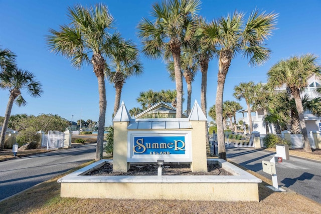 community sign with a gate and fence