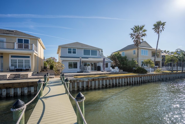 dock area featuring a water view and a balcony