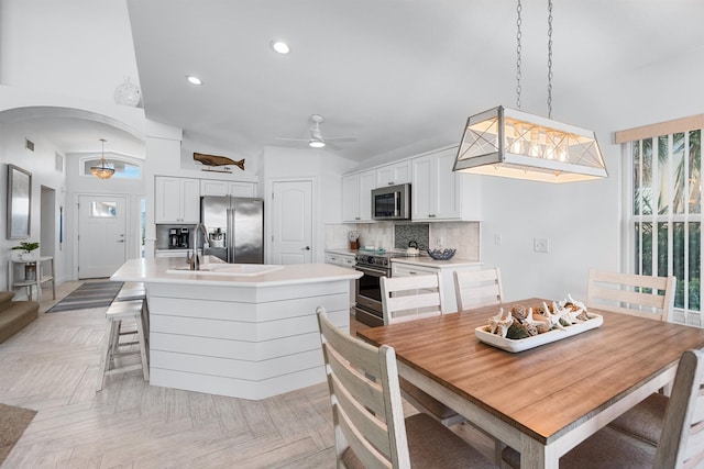 dining area featuring visible vents, arched walkways, a ceiling fan, and recessed lighting