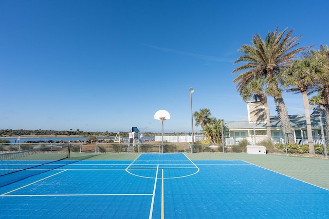 view of basketball court with community basketball court and fence