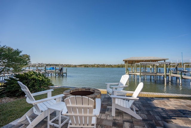 view of dock with a fire pit, a water view, and boat lift