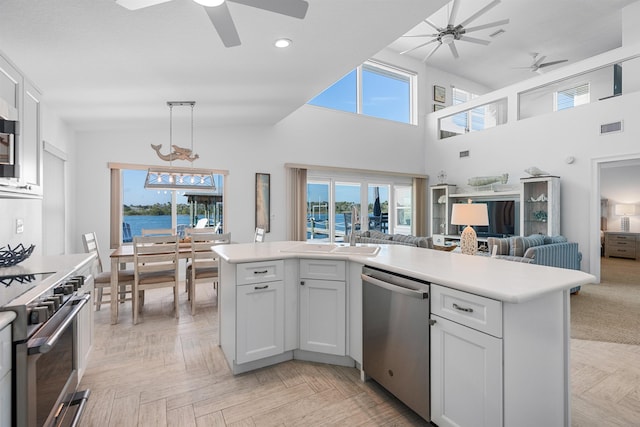 kitchen with visible vents, appliances with stainless steel finishes, open floor plan, light countertops, and white cabinetry