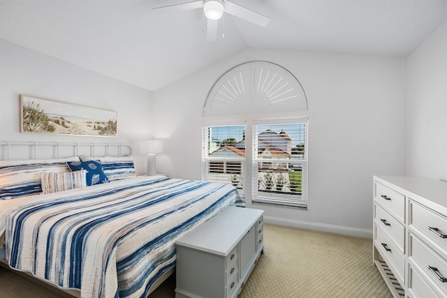 bedroom with lofted ceiling, baseboards, a ceiling fan, and light colored carpet