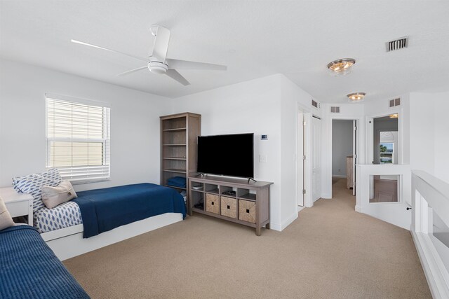 bedroom with visible vents, ceiling fan, light carpet, and baseboards