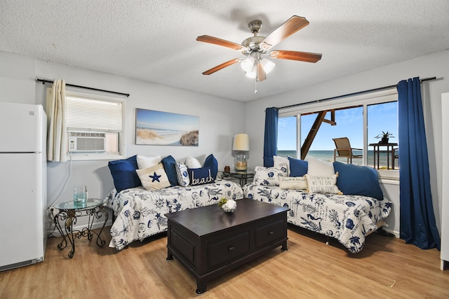 2749 S Ponte Vedra Blvd, Ponte Vedra Beach, FL 32082 - living room with light wood-type flooring, cooling unit, ceiling fan, and a textured ceiling